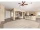 Open-concept living area with tiled flooring, a ceiling fan, and seamless connection to the kitchen area at 4109 E Del Rio St, Gilbert, AZ 85295