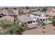 An elevated shot of an outdoor area featuring pool, fire pit, putting green, patio, and landscaping at 43851 W Griffis Dr, Maricopa, AZ 85138