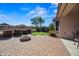 A beautiful shot of a putting green, fire pit, patio, and green landscaping in backyard at 43851 W Griffis Dr, Maricopa, AZ 85138