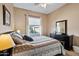 Cozy bedroom with a window, ceiling fan, and a neutral color scheme that creates a relaxing atmosphere at 43851 W Griffis Dr, Maricopa, AZ 85138