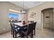 Charming dining room with a large table, seating for six, and a window offering beautiful views at 43851 W Griffis Dr, Maricopa, AZ 85138