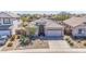 Inviting single-story home featuring desert landscaping, a tile roof, and an attached two-car garage at 43851 W Griffis Dr, Maricopa, AZ 85138