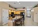 Well-equipped kitchen featuring a breakfast bar, wooden cabinetry, and modern appliances at 43851 W Griffis Dr, Maricopa, AZ 85138