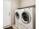 Laundry room features a washer, dryer, shelf, and access to the outside at 43851 W Griffis Dr, Maricopa, AZ 85138