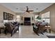 Bright living room with leather furniture, a TV, and large windows offering ample natural light at 43851 W Griffis Dr, Maricopa, AZ 85138