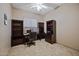 Home office featuring built-in dark wood desk, shelving, and neutral paint at 43851 W Griffis Dr, Maricopa, AZ 85138