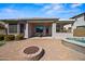 Backyard patio complete with a fire pit, pool, outdoor kitchen, and covered seating area at 43851 W Griffis Dr, Maricopa, AZ 85138