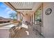 View of covered patio featuring a grill, stainless steel countertop, and outdoor dining area at 43851 W Griffis Dr, Maricopa, AZ 85138