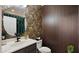 Stylish powder room with floral wallpaper, a modern black faucet, and a wood paneled wall at 4521 W Kirkland Ave, San Tan Valley, AZ 85144