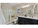 Bright bathroom with a double sink vanity, glass shower, and contemporary fixtures at 4521 W Kirkland Ave, San Tan Valley, AZ 85144