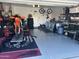 Spacious garage featuring epoxy flooring, motorcycle equipment, and ample storage solutions for the auto enthusiast at 4521 W Kirkland Ave, San Tan Valley, AZ 85144