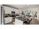 Modern kitchen featuring white cabinets, granite countertops, stainless steel appliances, and an island with seating at 4521 W Kirkland Ave, San Tan Valley, AZ 85144