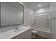 Well-lit bathroom with a framed mirror, white vanity, and a bathtub with white tile surround at 4655 S Glacier --, Mesa, AZ 85212