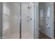 Walk-in shower featuring a glass door, white tile, and a built-in bench at 4655 S Glacier --, Mesa, AZ 85212