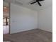 Bedroom with neutral carpet and doorway view to the balcony and exterior at 4655 S Glacier --, Mesa, AZ 85212