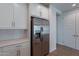 Kitchen area featuring stainless steel refrigerator and modern white cabinetry at 4655 S Glacier --, Mesa, AZ 85212