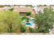 Aerial view of the home with a backyard oasis, including a pool, mature trees, and outdoor dining area at 4662 W Fallen Leaf Ln, Glendale, AZ 85310