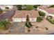 Aerial view of a single-Gathering home with a three-car garage, desert landscaping, and tile roof at 4662 W Fallen Leaf Ln, Glendale, AZ 85310