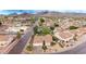 This aerial captures the lush landscaping and tile roofs of a desert neighborhood near the mountains at 4662 W Fallen Leaf Ln, Glendale, AZ 85310