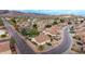 An aerial view of a suburban neighborhood in a desert community showcases tiled roofs and mountain views at 4662 W Fallen Leaf Ln, Glendale, AZ 85310