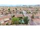 Aerial view of a neighborhood features tiled-roof homes, a backyard pool, and mature trees at 4662 W Fallen Leaf Ln, Glendale, AZ 85310