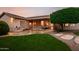 Inviting backyard featuring a patio, lush green lawn, and a built-in barbecue at 4662 W Fallen Leaf Ln, Glendale, AZ 85310