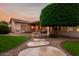 Inviting backyard featuring a patio, lush green lawn, built-in barbecue, and stepping stone path at 4662 W Fallen Leaf Ln, Glendale, AZ 85310