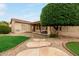 Inviting backyard featuring a patio, lush green lawn, built-in barbecue, and stepping stone path at 4662 W Fallen Leaf Ln, Glendale, AZ 85310