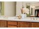 Bathroom featuring a double sink vanity with decorative accents and a mirror at 4662 W Fallen Leaf Ln, Glendale, AZ 85310