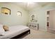 Light and airy bedroom featuring soft green walls, stylish storage, and a window view at 4662 W Fallen Leaf Ln, Glendale, AZ 85310