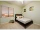 Serene bedroom with a dark wood bed, neutral decor, and a window providing natural light at 4662 W Fallen Leaf Ln, Glendale, AZ 85310