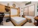 Cozy bedroom featuring a murphy bed with built-in shelving and workspace, complemented by a window view at 4662 W Fallen Leaf Ln, Glendale, AZ 85310