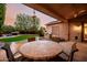 Covered patio with tile table, overlooking the pool and outdoor BBQ at 4662 W Fallen Leaf Ln, Glendale, AZ 85310