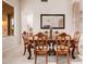 Formal dining room boasting an expansive wooden table, elegant chairs, and an oversized mirror at 4662 W Fallen Leaf Ln, Glendale, AZ 85310