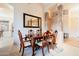 Dining room showcases classic wood table, elegant chairs, columns, and an oversized mirror at 4662 W Fallen Leaf Ln, Glendale, AZ 85310