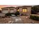 A charming home exterior displays a well-manicured yard, multiple garage doors, and stone accents at 4662 W Fallen Leaf Ln, Glendale, AZ 85310