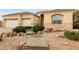 A charming home exterior displays a well-manicured yard, multiple garage doors, and stone accents at 4662 W Fallen Leaf Ln, Glendale, AZ 85310