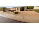 Single-story home with a well-manicured yard featuring desert landscaping and a mature, flowering shrub at 4662 W Fallen Leaf Ln, Glendale, AZ 85310