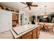 Spacious kitchen features a tiled island, wood cabinetry, and open layout perfect for modern living at 4662 W Fallen Leaf Ln, Glendale, AZ 85310