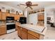 Kitchen boasts an island with tiled countertops and sleek appliances, great for gatherings and cooking at 4662 W Fallen Leaf Ln, Glendale, AZ 85310