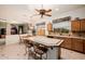 Kitchen boasts a center island with barstool seating and tiled countertops, creating a cozy gathering spot at 4662 W Fallen Leaf Ln, Glendale, AZ 85310