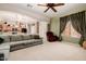 Bright living room with neutral carpet, a comfortable couch, and a glimpse into the adjacent kitchen at 4662 W Fallen Leaf Ln, Glendale, AZ 85310