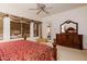 Another view of a spacious main bedroom featuring a large dresser and walk out to backyard at 4662 W Fallen Leaf Ln, Glendale, AZ 85310