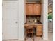 Small office nook with built-in cabinets, counterspace, and drawers located next to a door at 4662 W Fallen Leaf Ln, Glendale, AZ 85310