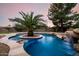 The backyard pool has a center island with a palm tree and a stone waterfall feature at 4662 W Fallen Leaf Ln, Glendale, AZ 85310