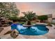 Stunning pool with rock waterfall and island palm tree, perfect for relaxation at 4662 W Fallen Leaf Ln, Glendale, AZ 85310