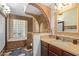 Unique bathroom design with a glass block shower, archway, and mosaic tile flooring at 4747 W Sunnyside Ave, Glendale, AZ 85304