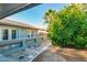 Backyard featuring a stone-style patio, lush fruit tree, and mature palm trees at 4747 W Sunnyside Ave, Glendale, AZ 85304