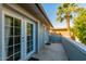 Side patio with access to a balcony, featuring palm trees and natural light at 4747 W Sunnyside Ave, Glendale, AZ 85304