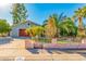 Inviting single-story home with meticulous landscaping, a cute fence, and mature palm trees at 4747 W Sunnyside Ave, Glendale, AZ 85304